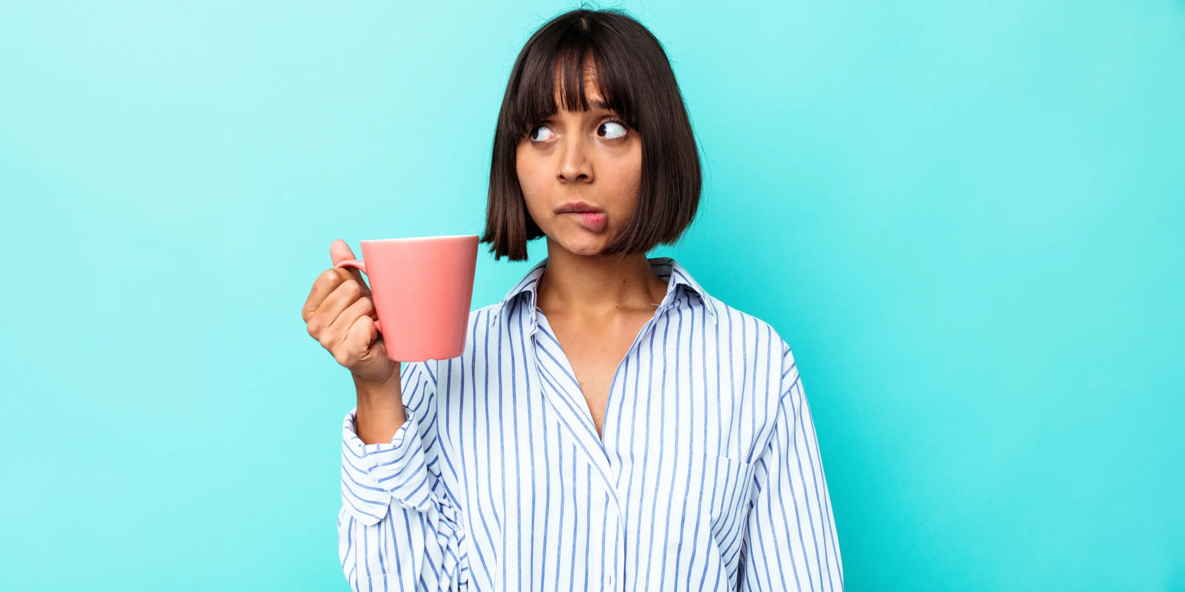 woman holding a mug and wondering something
